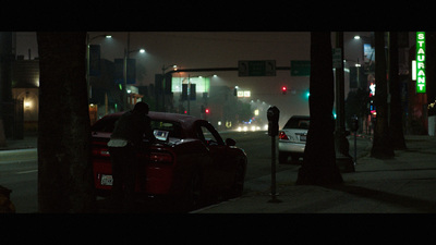 a car parked on the side of the road at night