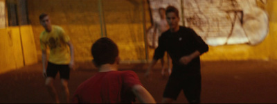 a group of young men playing a game of frisbee