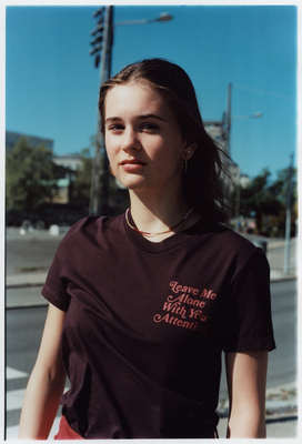 a woman standing on the side of the road