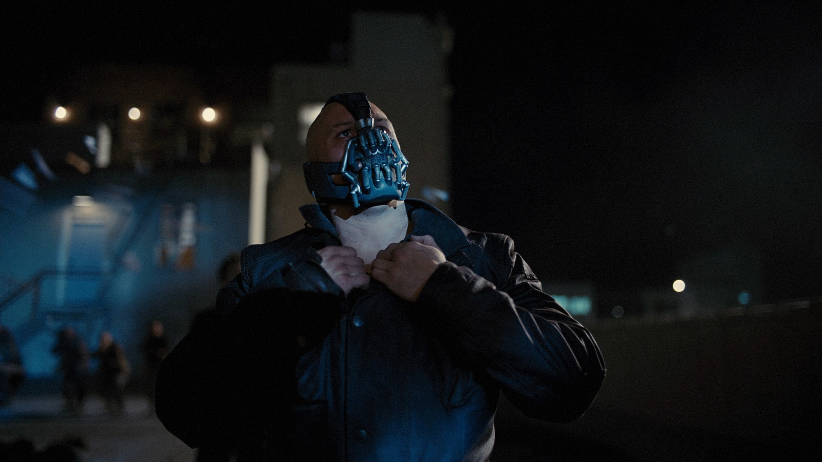 a man wearing a blue mask and a black jacket