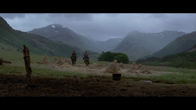 a group of people riding horses through a valley