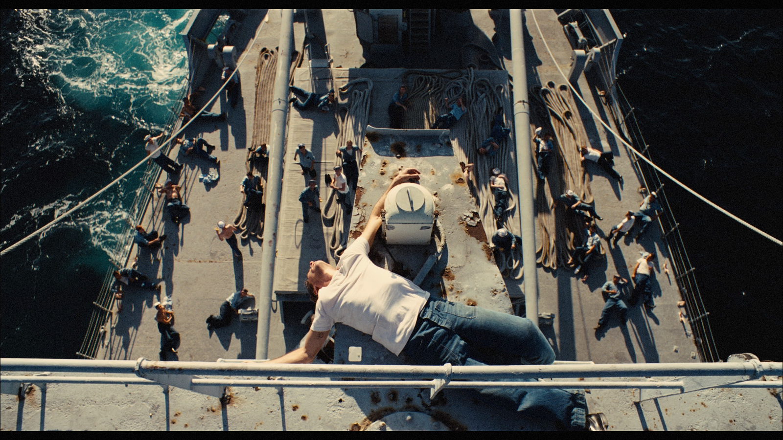 a man is sitting on the deck of a ship