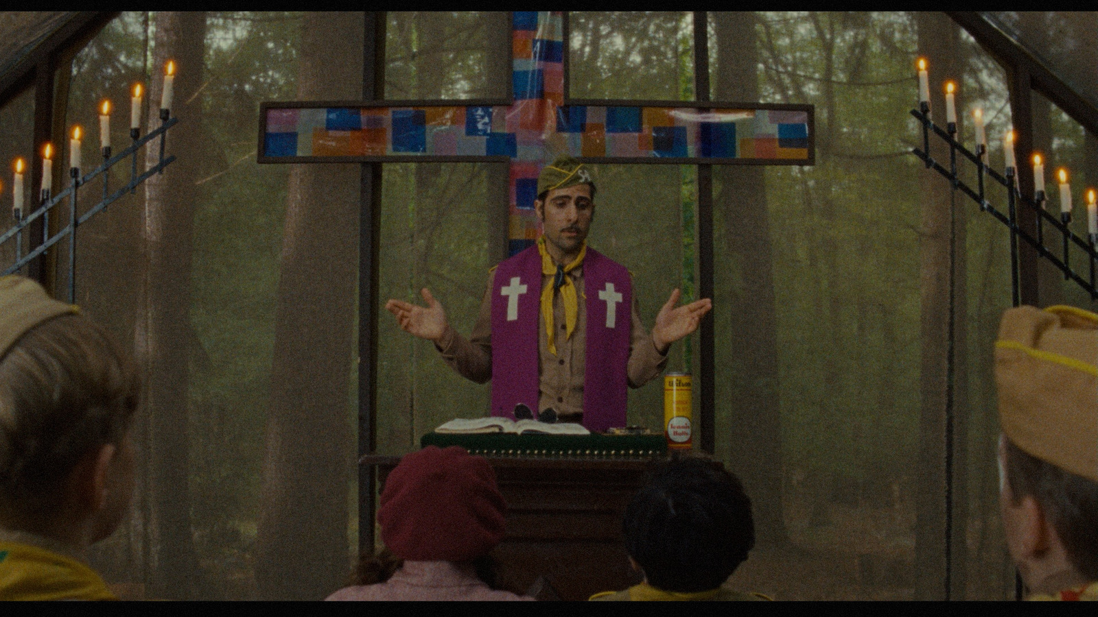 a man standing in front of a cross on top of a table