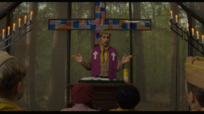 a man standing in front of a cross on top of a table