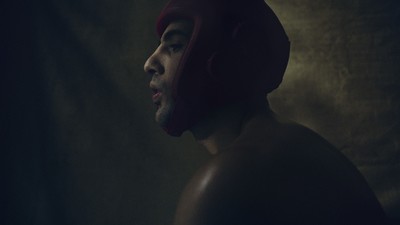 a man wearing a red helmet in a dark room