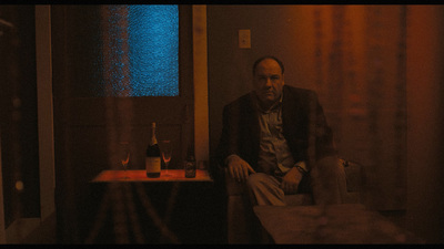 a man sitting on a bench in a dimly lit room