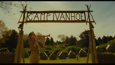 a man playing a trumpet under a wooden sign