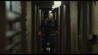 a man walking down a hallway in a building