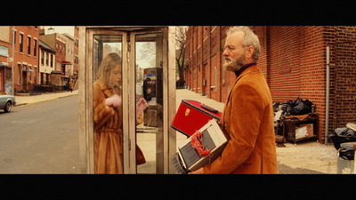 a man in a brown suit and a woman in a brown dress