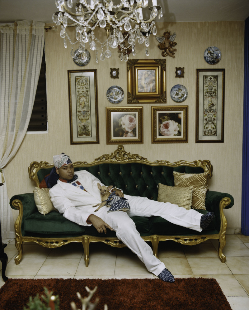 a man sitting on a couch in a living room