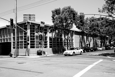 a black and white photo of a street corner