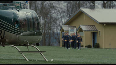 a helicopter sitting on top of a lush green field