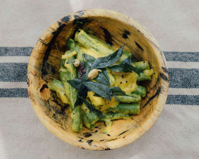 a wooden bowl filled with food on top of a table