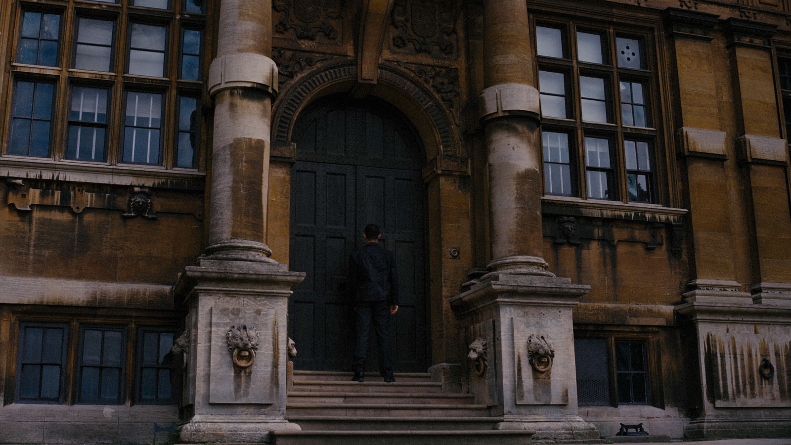 a man standing in front of a large building