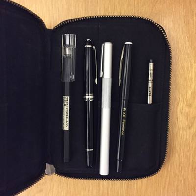 a pen, a pen, and some other items in a case