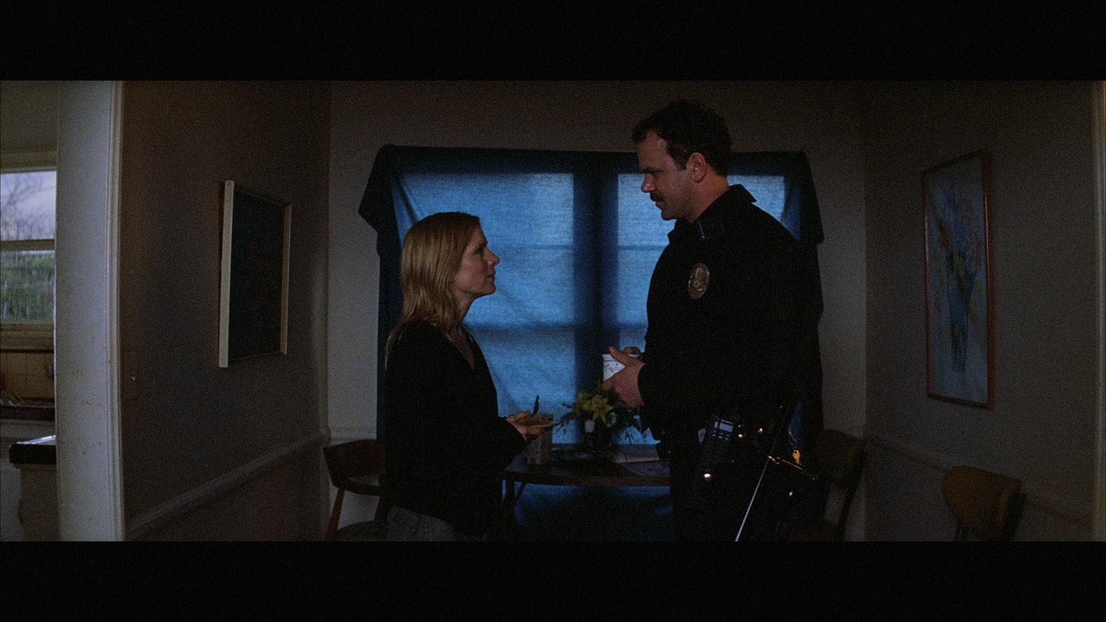 a police officer talking to a woman at a table