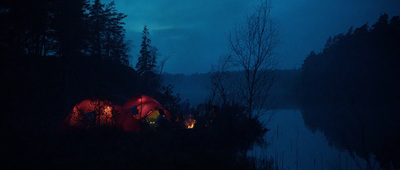 a couple of tents sitting in the middle of a forest