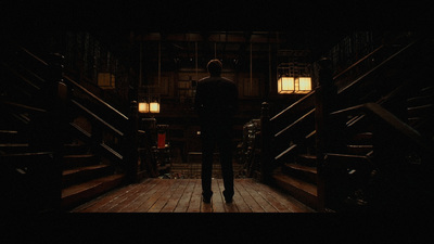 a man in a suit is standing on a set of stairs