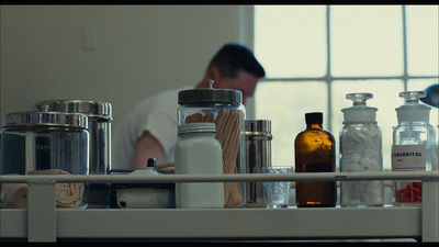 a man standing in front of a counter filled with bottles