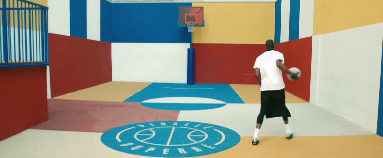 a man in a white shirt is holding a basketball