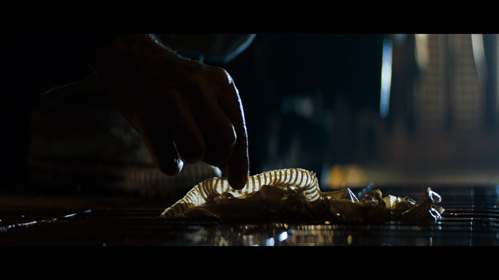 a person reaching for a piece of food on a table