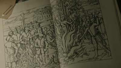 an open book with a drawing of a group of people