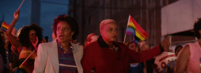 a group of people standing around each other holding flags