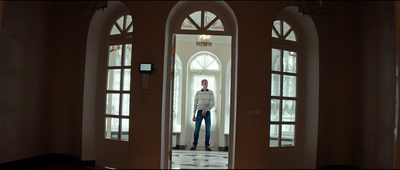 a man standing in a doorway of a house