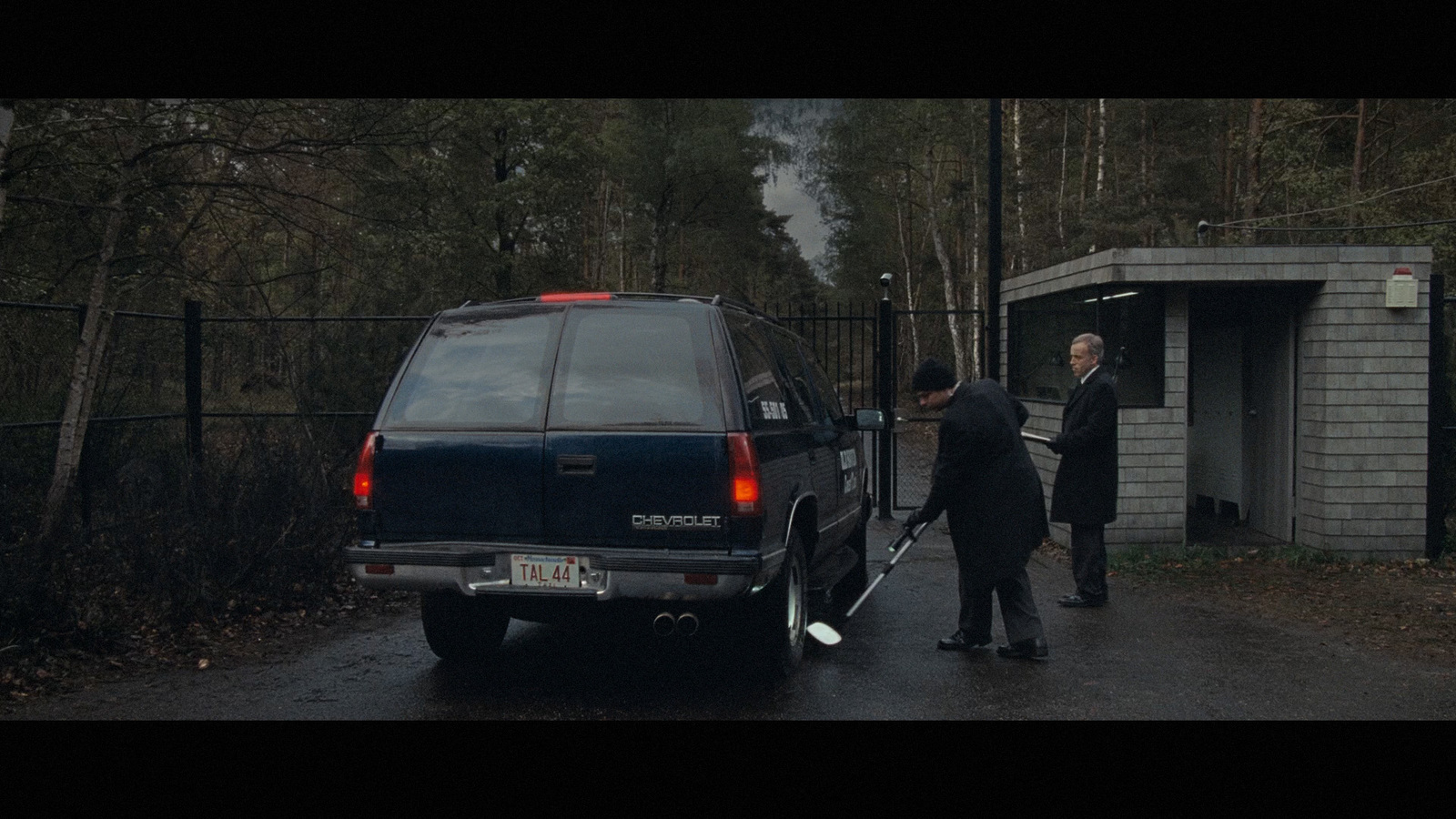 a couple of men standing next to a van