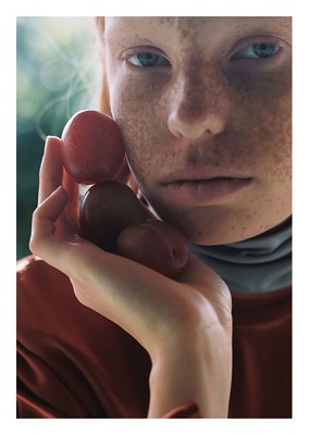 a woman with freckled hair holding a red object