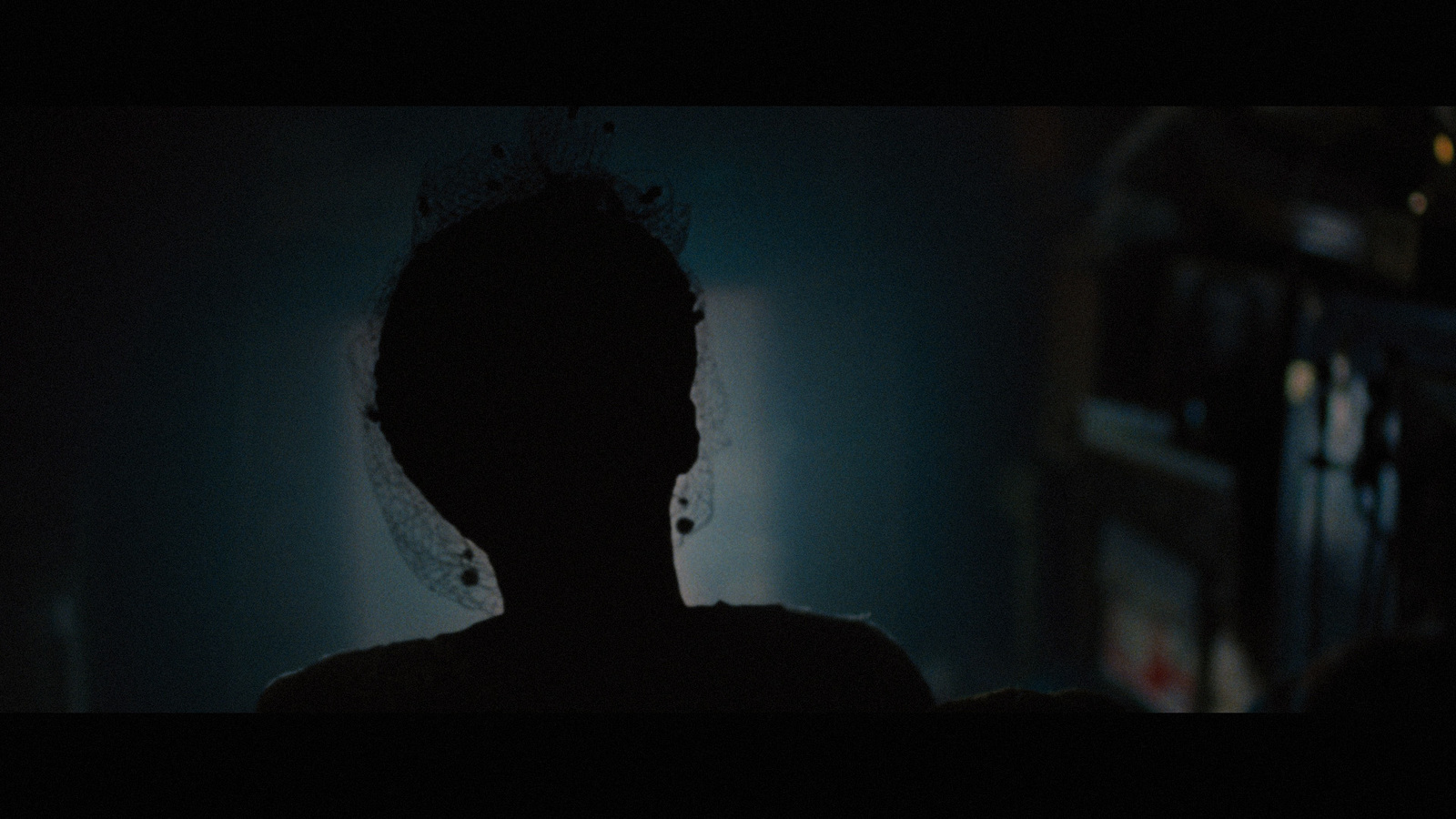 a silhouette of a person in a dark room