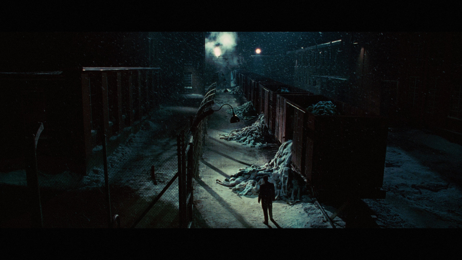 a person walking down a snowy street at night