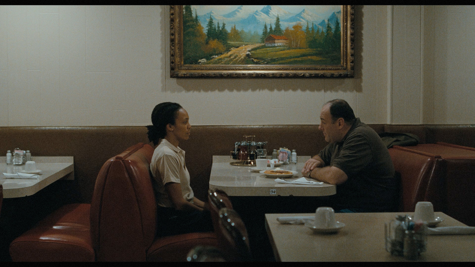 a man and woman sitting at a table in a restaurant