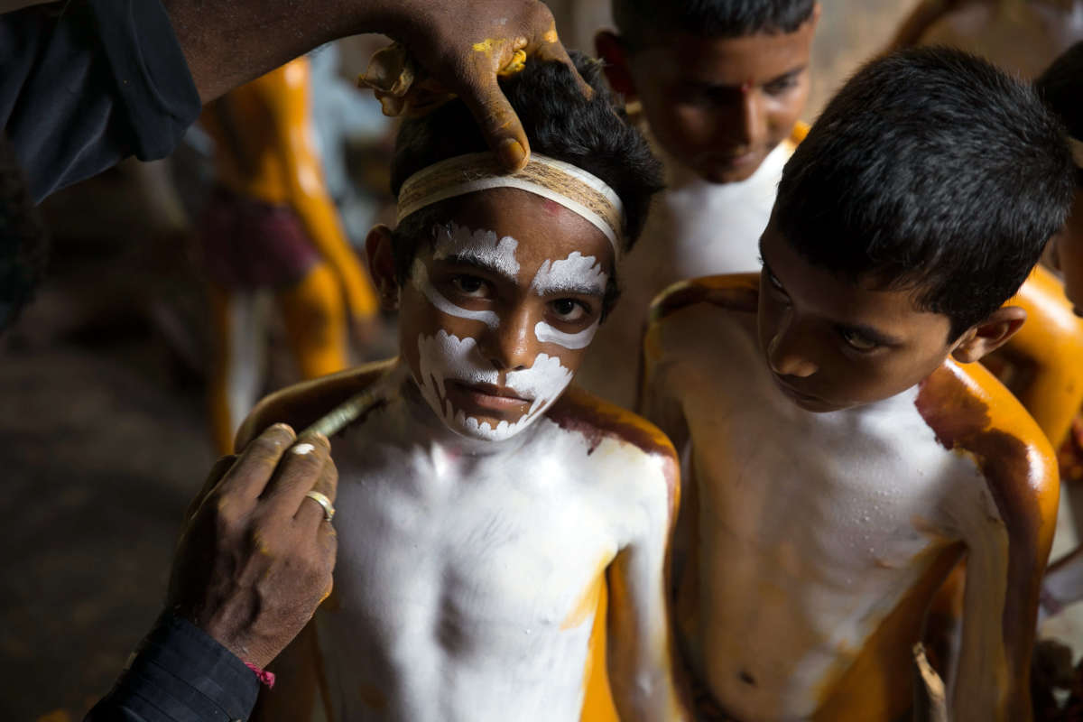 a group of people with white paint on their faces