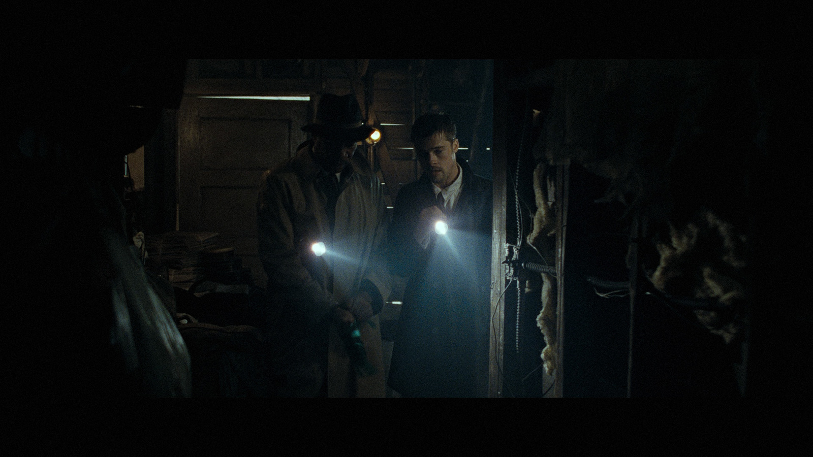 a group of men standing next to each other in a dark room