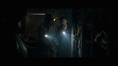 a group of men standing next to each other in a dark room