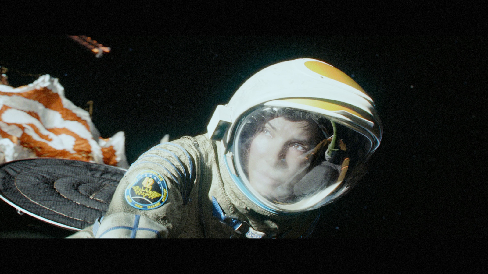 a man in a space suit with a space shuttle in the background