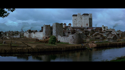 a large castle like structure next to a body of water