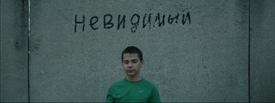 a man standing in front of a wall with graffiti on it