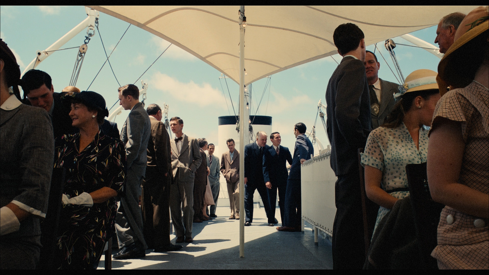 a group of people standing on top of a boat