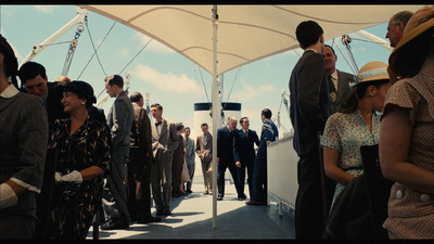 a group of people standing on top of a boat