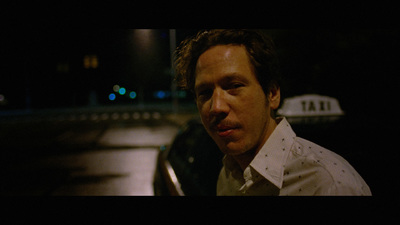 a man standing in front of a car at night