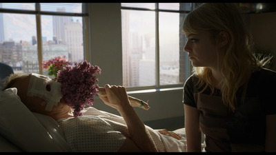 a woman laying in bed with a mask on her face