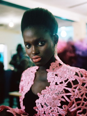 a woman in a pink dress posing for a picture