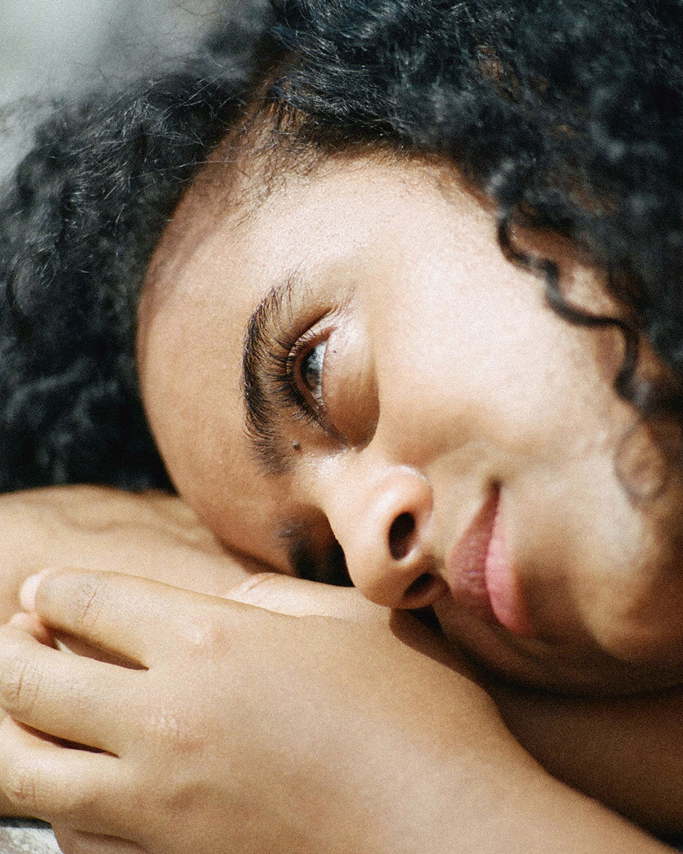 a close up of a person laying on a bed