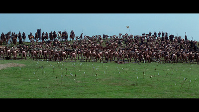 a large group of people on horses in a field