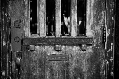 a black and white photo of a wooden door