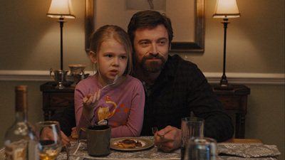 a man and a little girl sitting at a table