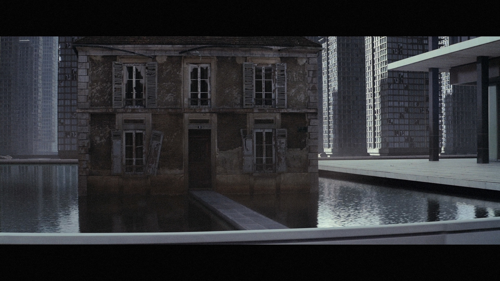 a reflection of a building in a pool of water