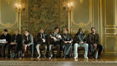 a group of people sitting on top of a wooden bench